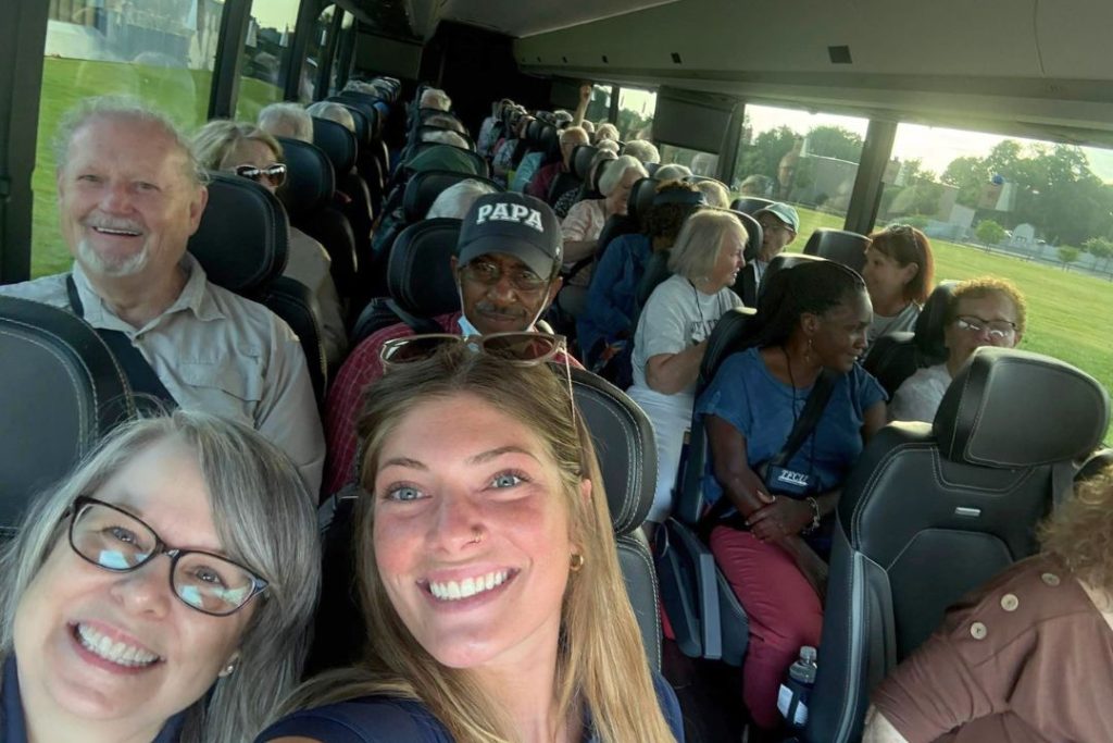 People smiling on a tour bus