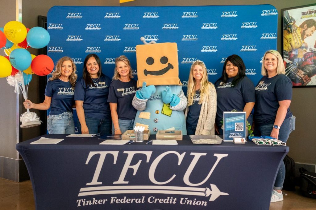 TFCU employees and Sav-A-Tron stand behind a table