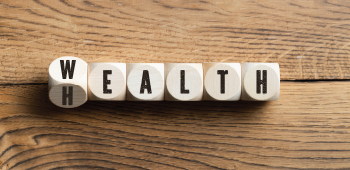 Letter blocks spelling out Wealth or Health