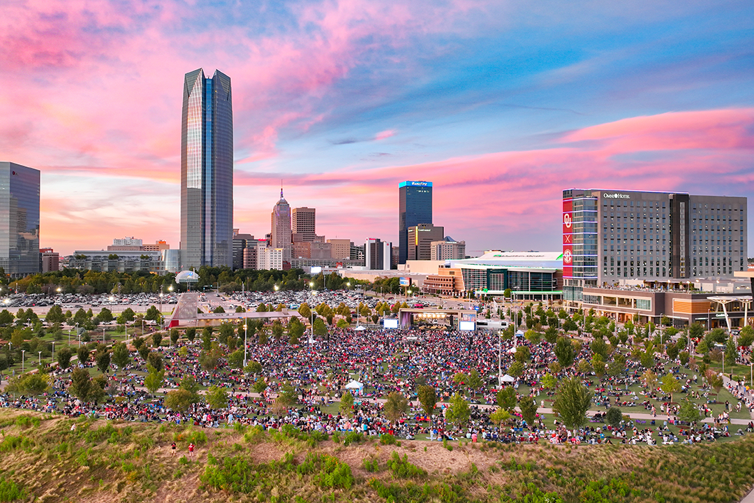 Drone shot of the scissortail park with a crowd of people.