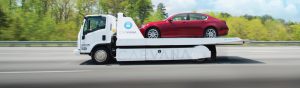 Carvana truck carrying a car to be delivered to a buyer