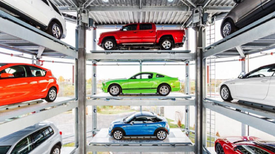 Colorful cars stacked in a display representing Carvana inventory ready to buy.
