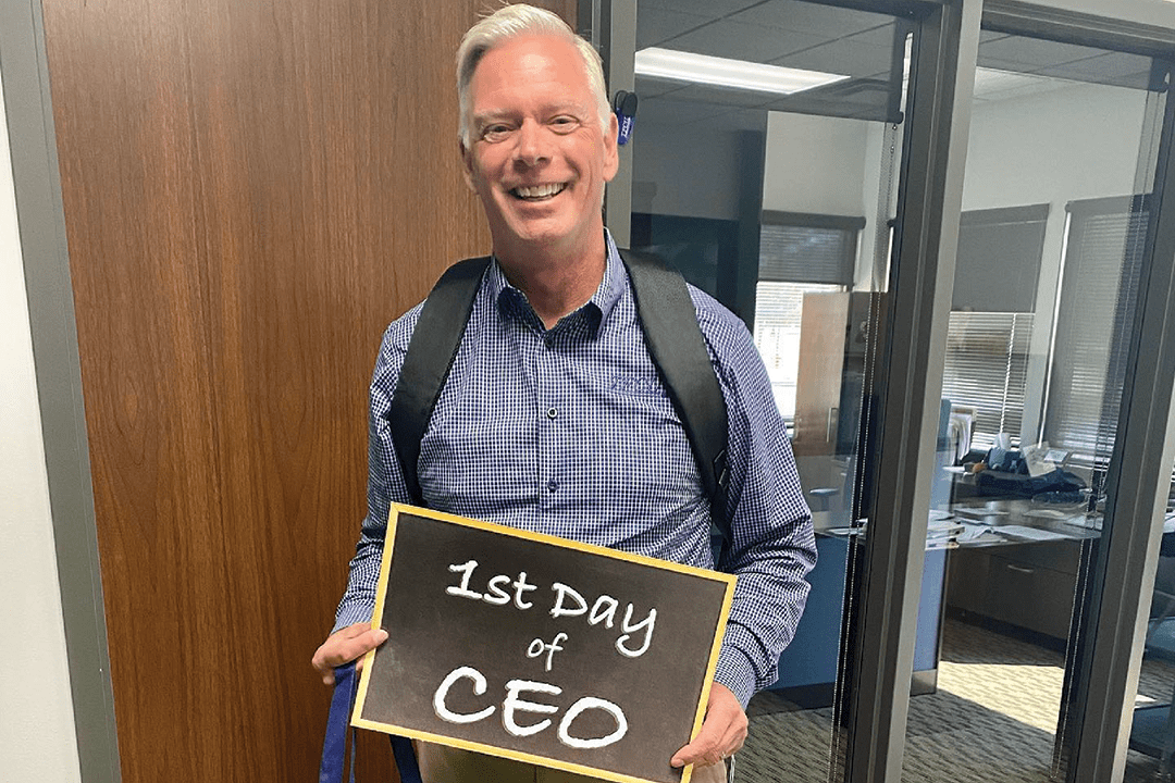 CEO Dave Willis holding a sign