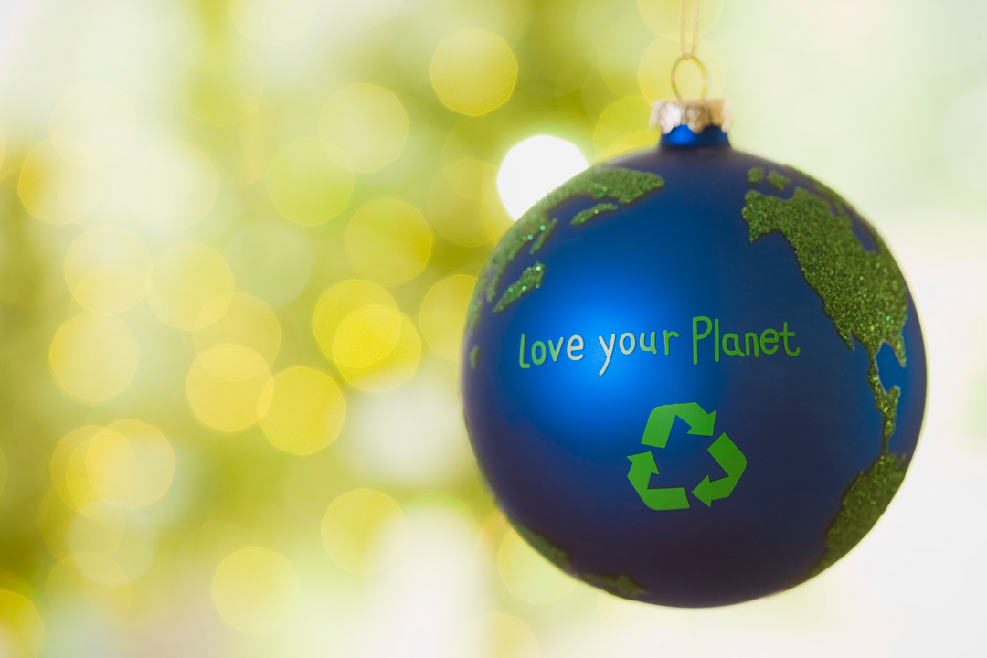 Close up of an ornament that looks like earth with the words Love Your Planet on it.
