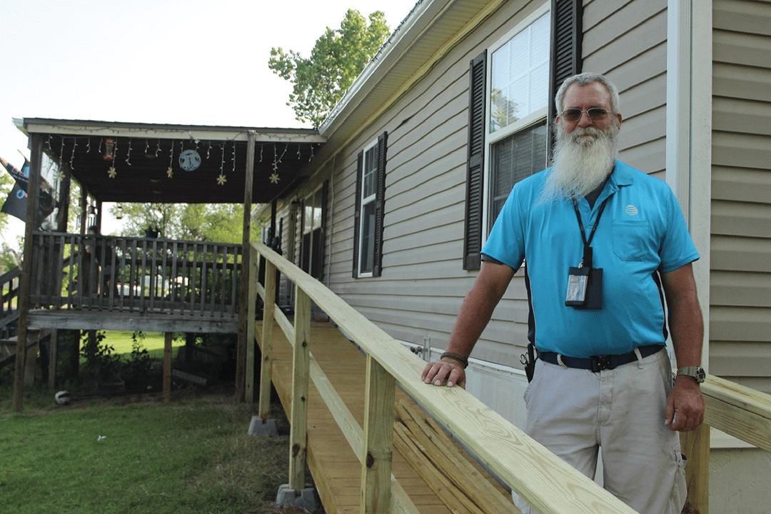 Man standing outside his home