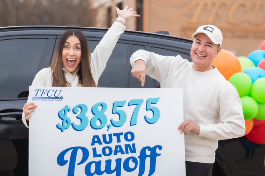 Happy woman and man holding sign showing they won $38,575,