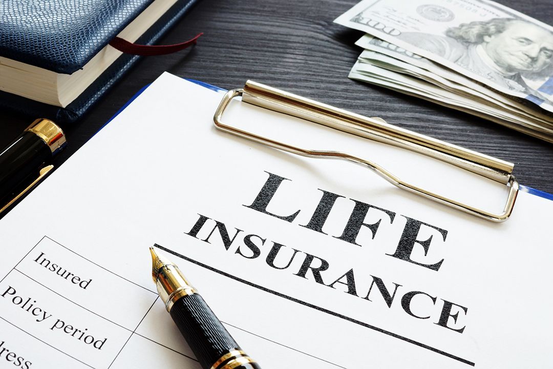 Paper in a clipboard that says life insurance