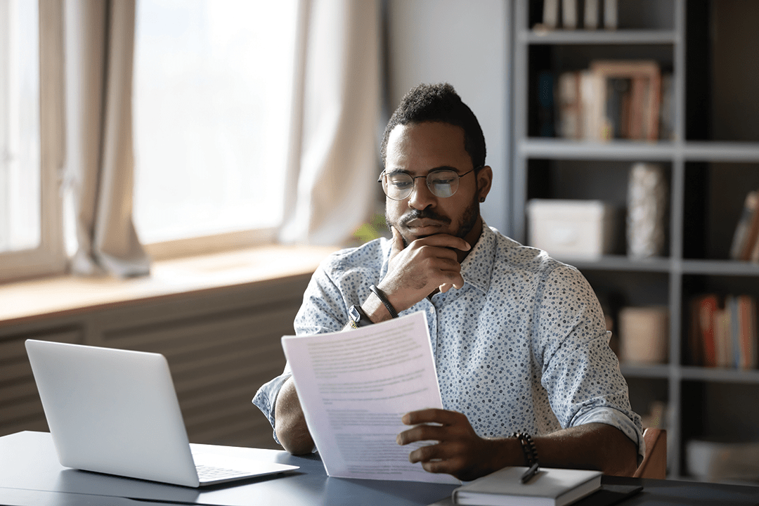 A man looking seriously at a paper