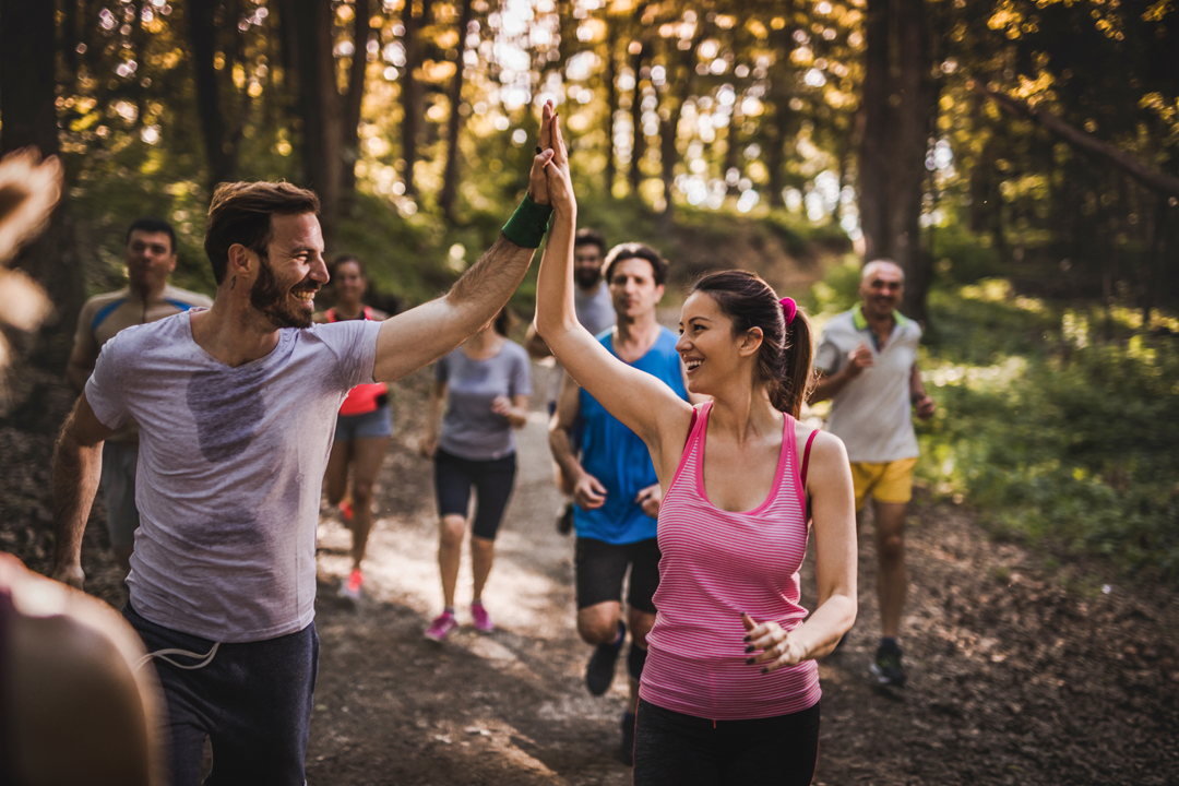 Man and woman high-fiving after a long run.