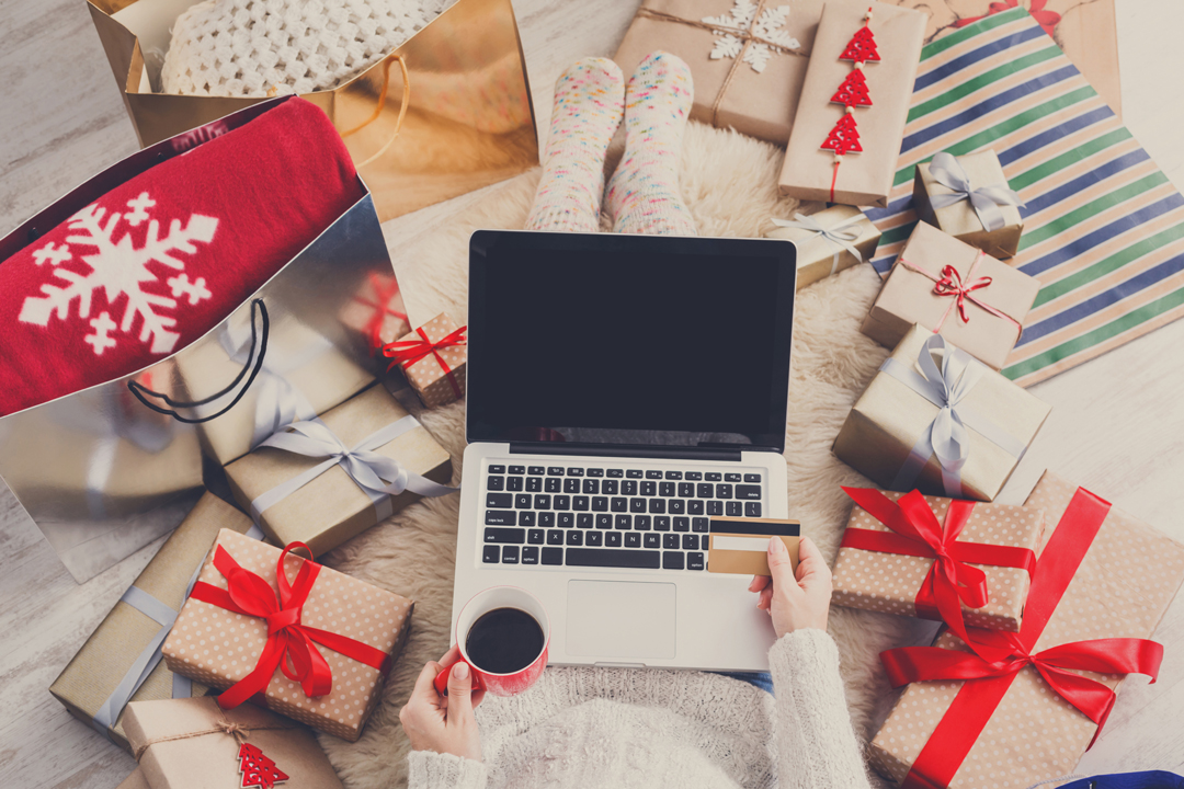 Woman drinking coffee and shopping online for the holidays