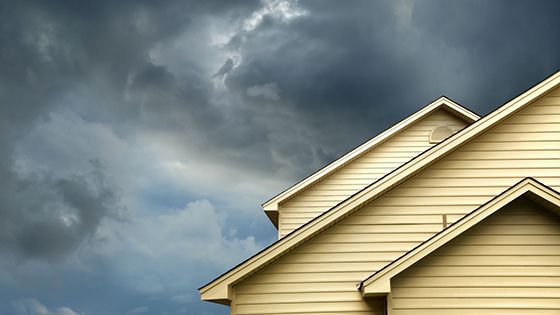 Top of roof with stormy skies in the background