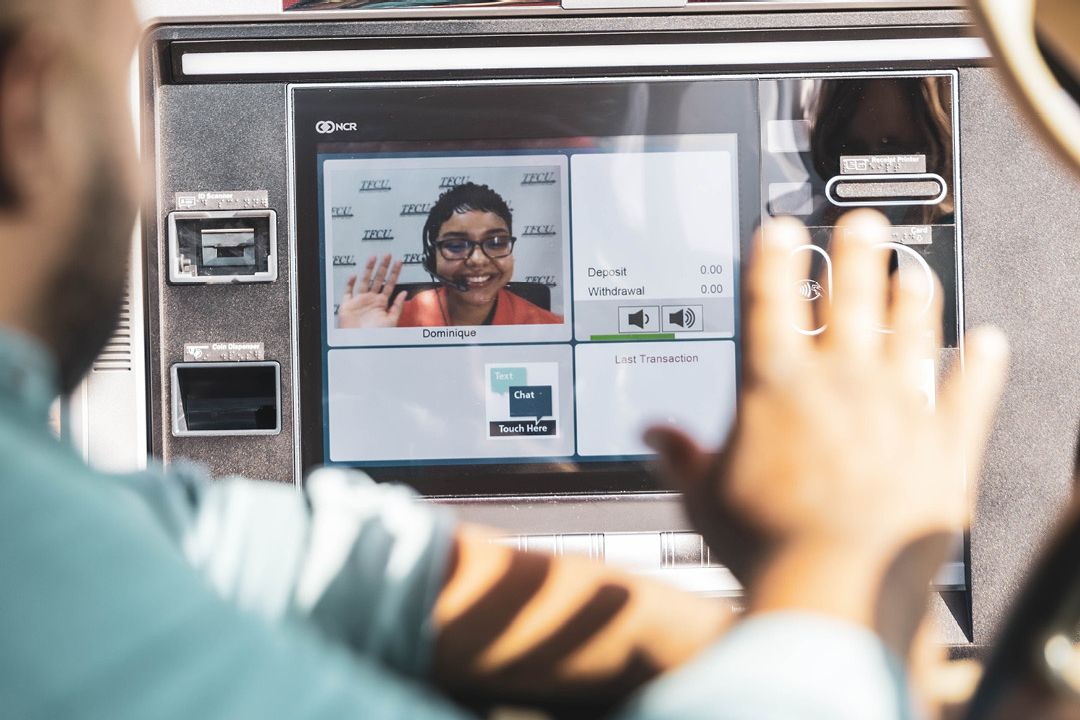A man waves at a teller on the ITM
