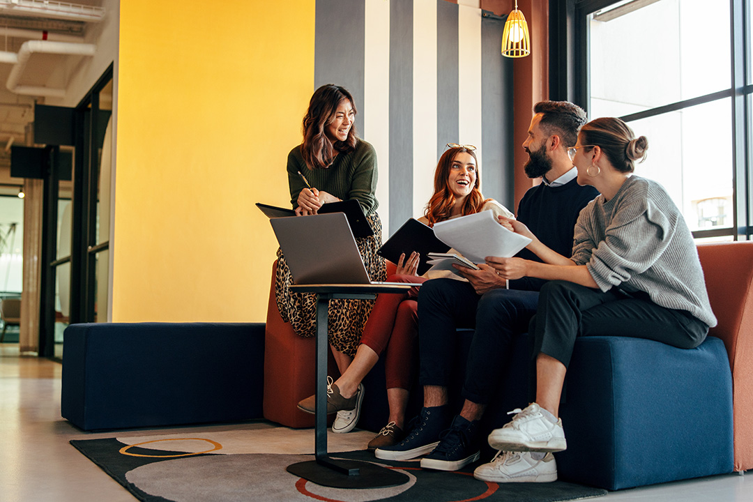 A group of people sitting together in a meeting