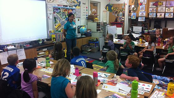 Someone teaching in a classroom full of students