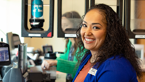 employee wearing royal blue blouse smiling