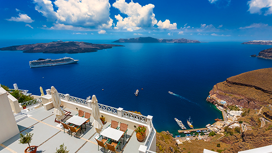 Beautiful ocean view from balcony in Greece with cruise ship in the distance.