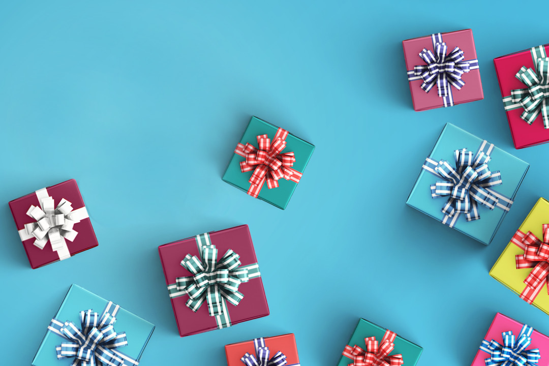 A scatter of gift boxes on a light blue background.