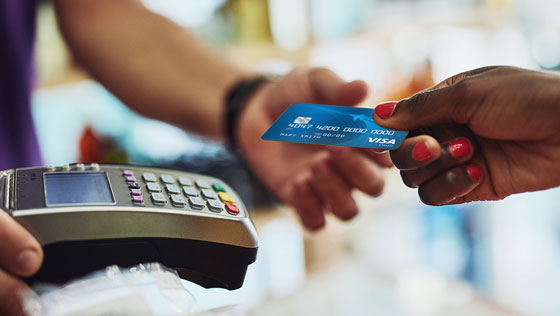 Close up of member making a store purchas with a TFCU Visa Classic credit card