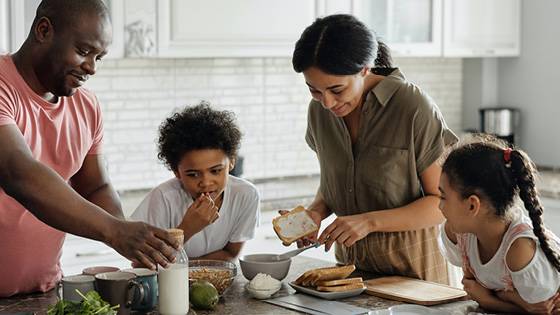 A family cooking in the kitchen with their kids