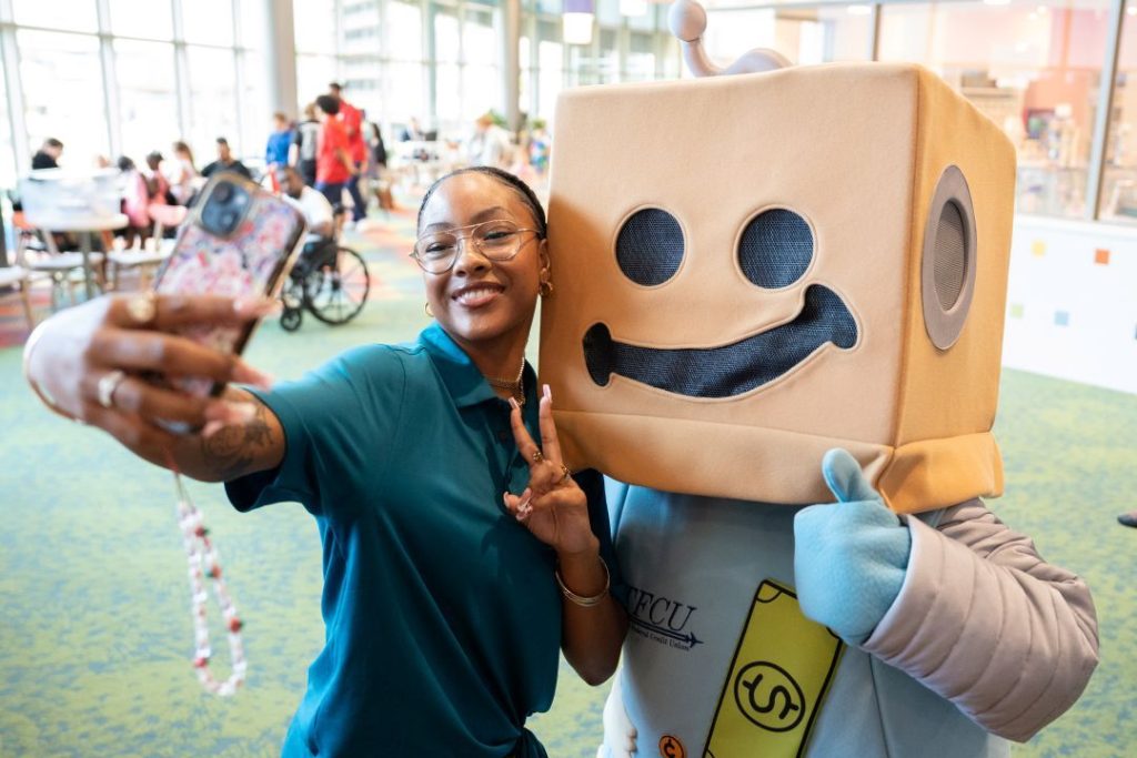 A woman takes a selfie with Sav-A-Tron