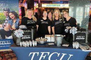 Group of TFCU employees in front of table