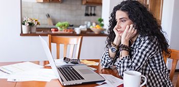 Woman Worrying Looking at her laptop