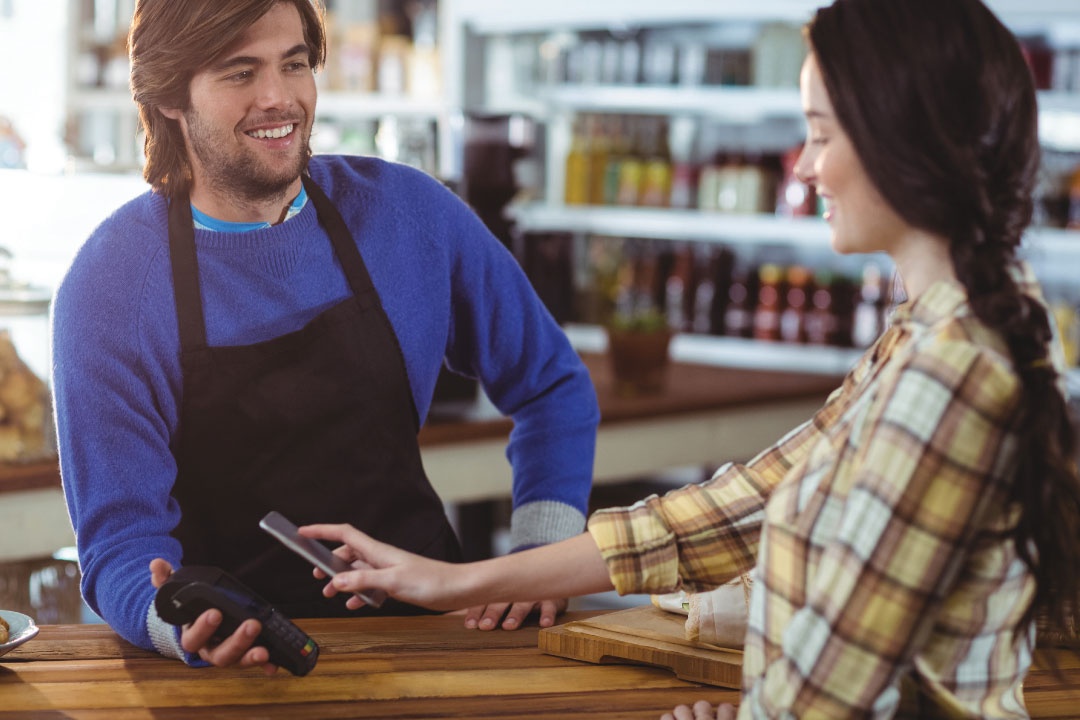 Young man using a digital wallet to pay for a puchase