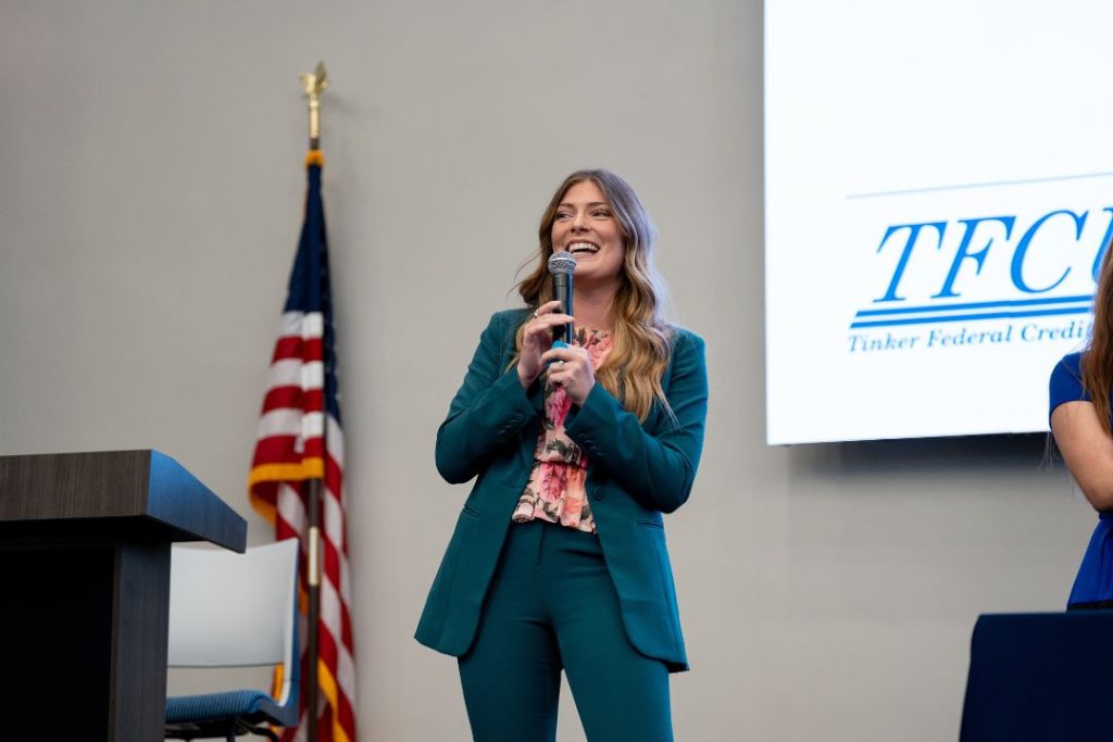 A business woman speaks on stage