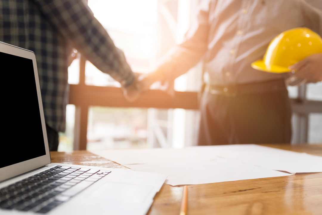 Home owner shaking hands with a building contractor